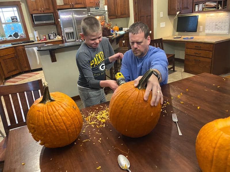 Karl and son carving pumpkins Karl and son carving pumpkins